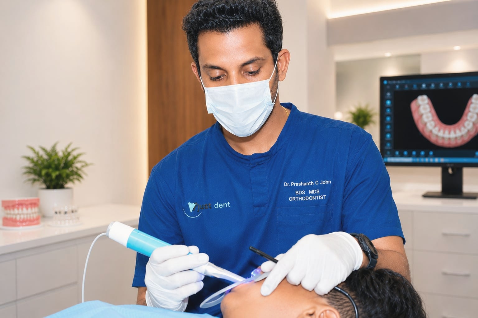 Dr. Prashanth C John treating a patient at Just Dent